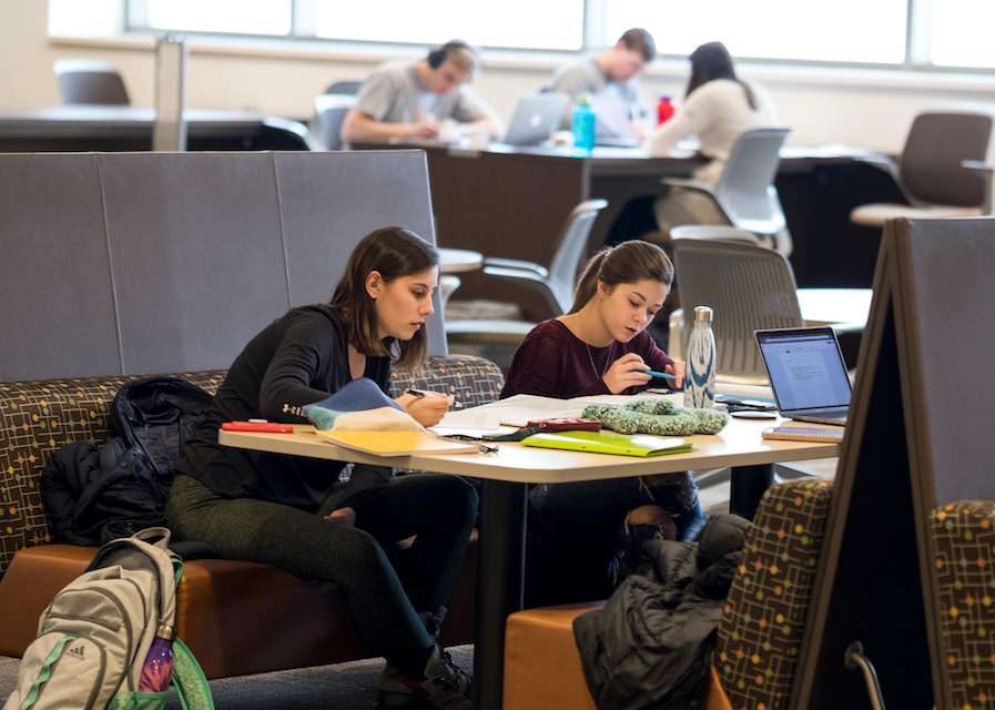 Students studying at a table in the library.