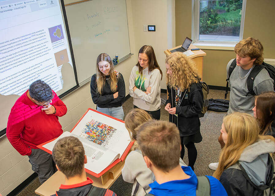 Theology and religious studies students have an in-class discussion with their professor, Thomas Bolin.