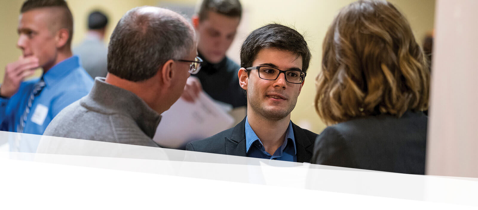 Students talks to prospective employers at a job fair on campus