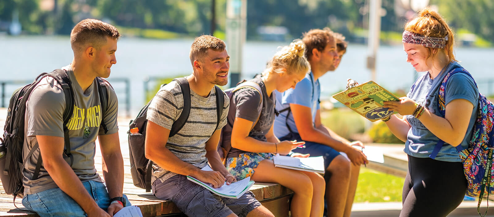 Students do homework together by the river