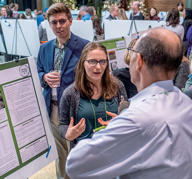 Student talks with community member about a research project